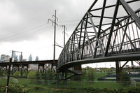 The Goldie Paley Bridge (right) glides under the CSX freight highline (left), and connects Penn Park to<br><a href=http://bit.ly/1KOwm5z>Shoemaker Green</a>.